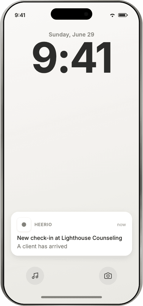 iPhone lock screen with a Heerio push notification: new check-in at Lighthouse Counseling, a client has arrived
